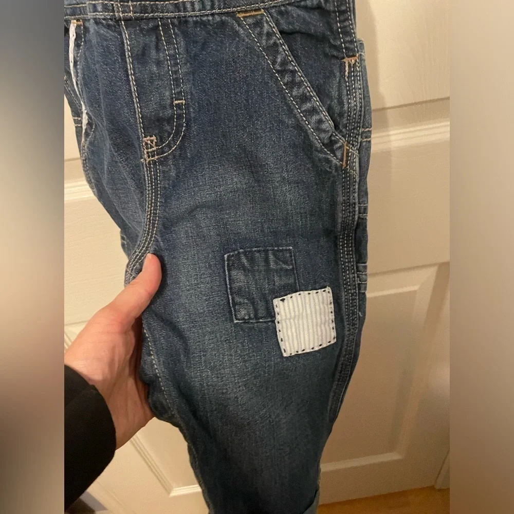 Osh Kosh Denim overalls with patches and spell out